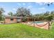 Backyard oasis featuring a kidney-shaped pool and wooden deck at 209 Orange Dr, Lutz, FL 33548