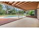 Relaxing pool area with covered patio and wooden deck at 209 Orange Dr, Lutz, FL 33548