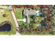 Expansive property featuring a large home, lush landscaping, sparkling pool, and a serene pond at 2501 Rustic Oaks Dr, Lutz, FL 33559