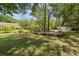 Expansive backyard with mature trees and a separate outbuilding, ideal for recreation and relaxation at 2501 Rustic Oaks Dr, Lutz, FL 33559