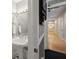 Hall bathroom featuring classic fixtures, a pedestal sink, and a view down the hallway, exuding vintage charm at 2501 Rustic Oaks Dr, Lutz, FL 33559