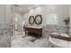 Bathroom includes marble floors, a walk-in shower, and standalone tub at 2501 Rustic Oaks Dr, Lutz, FL 33559