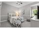 Cozy bedroom features carpet floors, decorative pillows, and a ceiling fan at 2501 Rustic Oaks Dr, Lutz, FL 33559