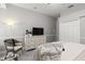 This bedroom features a dresser with mounted TV, carpet floors, and closet at 2501 Rustic Oaks Dr, Lutz, FL 33559