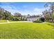 Inviting single-story home with a meticulously maintained lawn and an attached three-car garage at 2501 Rustic Oaks Dr, Lutz, FL 33559