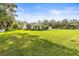 Single-story home featuring a brick chimney and a lush green lawn at 2501 Rustic Oaks Dr, Lutz, FL 33559
