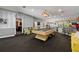Entertainmant space featuring a pool table, bar area, and striped walls, ideal for gatherings and recreation at 2501 Rustic Oaks Dr, Lutz, FL 33559