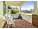 Relaxing front porch with white wicker chairs and view of the yard at 2501 Rustic Oaks Dr, Lutz, FL 33559