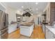 Open kitchen with dual islands, custom cabinetry, granite counters, and stainless steel appliances at 2501 Rustic Oaks Dr, Lutz, FL 33559