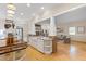 Open concept kitchen with a breakfast bar, stainless steel appliances, and hardwood floors throughout at 2501 Rustic Oaks Dr, Lutz, FL 33559