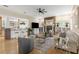 Inviting living room with a brick fireplace, open floor plan, and seamless flow into the kitchen at 2501 Rustic Oaks Dr, Lutz, FL 33559