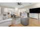 Open-concept living room boasts hardwood floors, neutral tones, and seamless flow into the adjacent kitchen and dining areas at 2501 Rustic Oaks Dr, Lutz, FL 33559