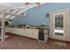 Covered patio with a built-in outdoor kitchen, perfect for entertaining and enjoying outdoor dining at 2501 Rustic Oaks Dr, Lutz, FL 33559