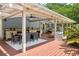 Expansive outdoor patio with a dining table and a full kitchen, ideal for outdoor entertaining at 2501 Rustic Oaks Dr, Lutz, FL 33559