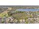 Aerial view of community showing surrounding landscape and lake at 3020 Bonaventure Cir # 102, Palm Harbor, FL 34684