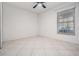 Simple bedroom with tile floors and window coverings at 3020 Bonaventure Cir # 102, Palm Harbor, FL 34684