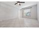 Bedroom with tile floor and ceiling fan at 3020 Bonaventure Cir # 102, Palm Harbor, FL 34684