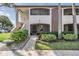 Condo building exterior with walkway and landscaping at 3020 Bonaventure Cir # 102, Palm Harbor, FL 34684