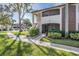 Condo building exterior with walkway and landscaping at 3020 Bonaventure Cir # 102, Palm Harbor, FL 34684