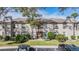 Condo building exterior with landscaping and parking at 3020 Bonaventure Cir # 102, Palm Harbor, FL 34684