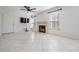 Living room featuring tile floors, fireplace and ceiling fan at 3020 Bonaventure Cir # 102, Palm Harbor, FL 34684