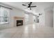 Bright living room with tile floors, fireplace, and ceiling fan at 3020 Bonaventure Cir # 102, Palm Harbor, FL 34684