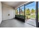Screened-in porch with access to a grassy area at 3020 Bonaventure Cir # 102, Palm Harbor, FL 34684