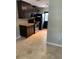Galley kitchen with dark cabinets, stainless steel appliances, and tile floor at 3402 W Obispo St, Tampa, FL 33629