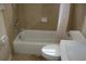 Bathroom with tub, shower, and updated toilet and sink at 3402 W Obispo St, Tampa, FL 33629