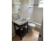 Bathroom with white tile, pedestal sink, and a bathtub at 3402 W Obispo St, Tampa, FL 33629