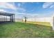 Fenced backyard with a small tree and a screened structure at 37127 Goffaux Loop, Zephyrhills, FL 33541