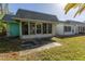 View of teal house with screened porch at 4223 Terrapin Pl, New Port Richey, FL 34652