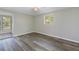 Well-lit bedroom with wood-look flooring and a view of the backyard at 4223 Terrapin Pl, New Port Richey, FL 34652