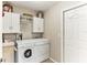 Bright laundry room, washer, dryer, cabinets, and extra storage at 4921 Edgewater Ln, Oldsmar, FL 34677