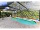 Relaxing kidney-shaped pool with screened enclosure at 4921 Edgewater Ln, Oldsmar, FL 34677