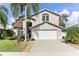 Two-story house with a large driveway and landscaping at 4921 Edgewater Ln, Oldsmar, FL 34677