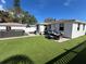 Artificial turf backyard with patio furniture and a hot tub at 507 79Th Ave, St Pete Beach, FL 33706