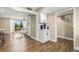 Bright hallway with wood floors, offering views into the living room and kitchen at 6315 Newtown Cir # 15B6, Tampa, FL 33615