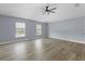 Spacious bedroom with wood-look floors and two windows at 6489 Hazelwood Rd, Spring Hill, FL 34608