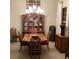 Formal dining room with a wood table, hutch, and chandelier at 297 Martellago Dr, North Venice, FL 34275