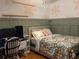 Bedroom with a double bed, green walls, and a work station at 1003 W Mahoney St, Plant City, FL 33563