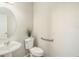 Clean bathroom with toilet, sink, and grab bar at 10236 Newminster Loop, Ruskin, FL 33573