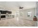 Open concept kitchen with dark cabinets, granite countertops, and an island at 10236 Newminster Loop, Ruskin, FL 33573