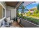 Relaxing screened porch with seating area overlooking a pond at 10263 Gandy N Blvd # 107, St Petersburg, FL 33702