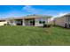 House backyard view with patio and landscaping at 18027 Turning Leaf Cir, Land O Lakes, FL 34638