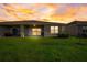 House backyard view at sunset with patio at 18027 Turning Leaf Cir, Land O Lakes, FL 34638