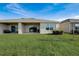 House backyard view with patio and landscaping at 18027 Turning Leaf Cir, Land O Lakes, FL 34638