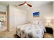 Well-lit bedroom with a queen-size bed and access to a full bathroom at 18027 Turning Leaf Cir, Land O Lakes, FL 34638