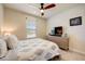Comfortable bedroom with a queen-size bed and built-in TV stand at 18027 Turning Leaf Cir, Land O Lakes, FL 34638