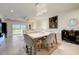 Modern dining room featuring a marble table, chandelier and adjacent living space at 18027 Turning Leaf Cir, Land O Lakes, FL 34638